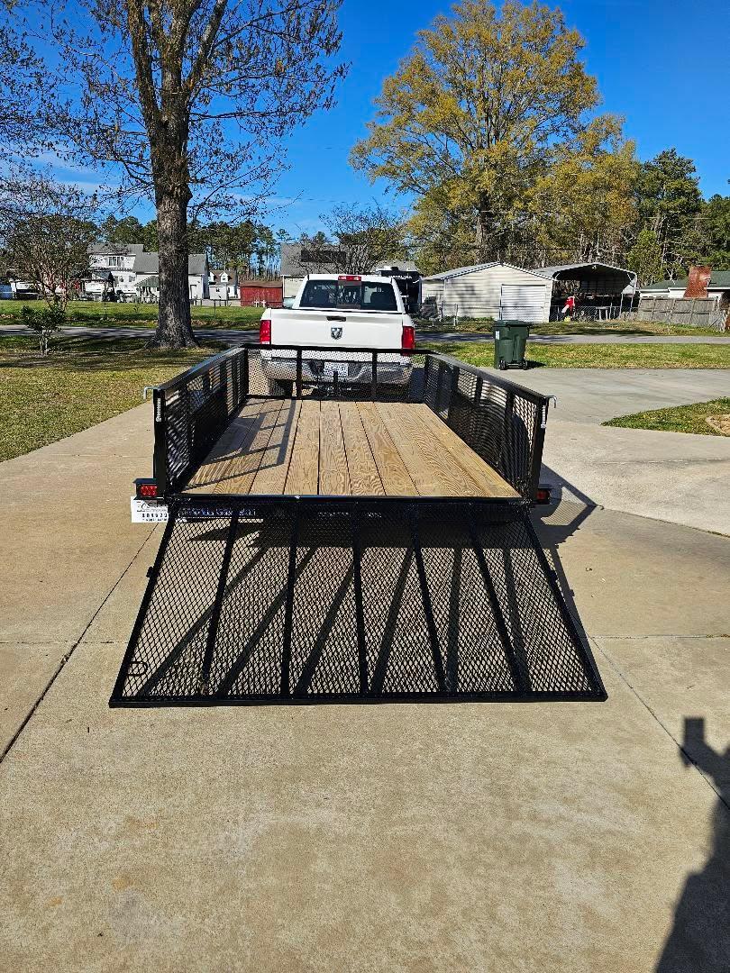 Utility trailer with wood deck and rear ramp gate